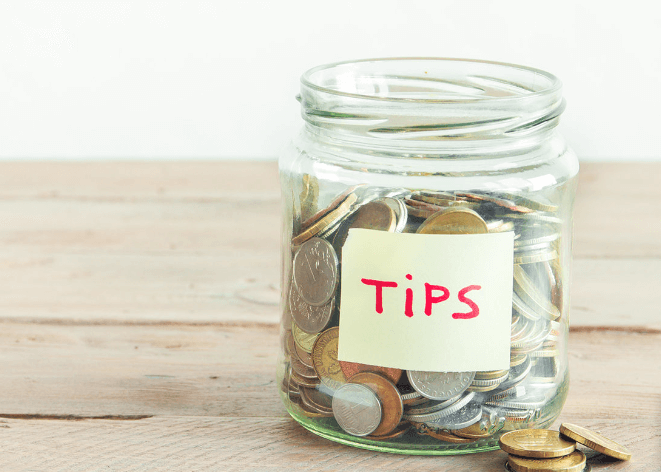 Tips jar on wooden table